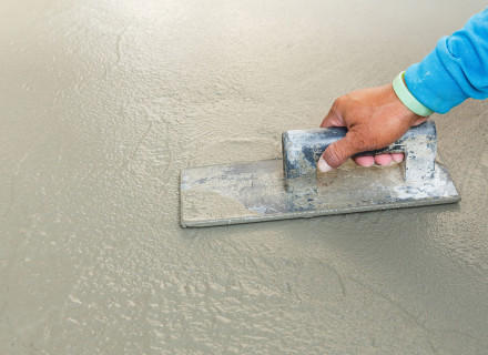 Finishing poured concrete, Cayman Concrete Pumping.